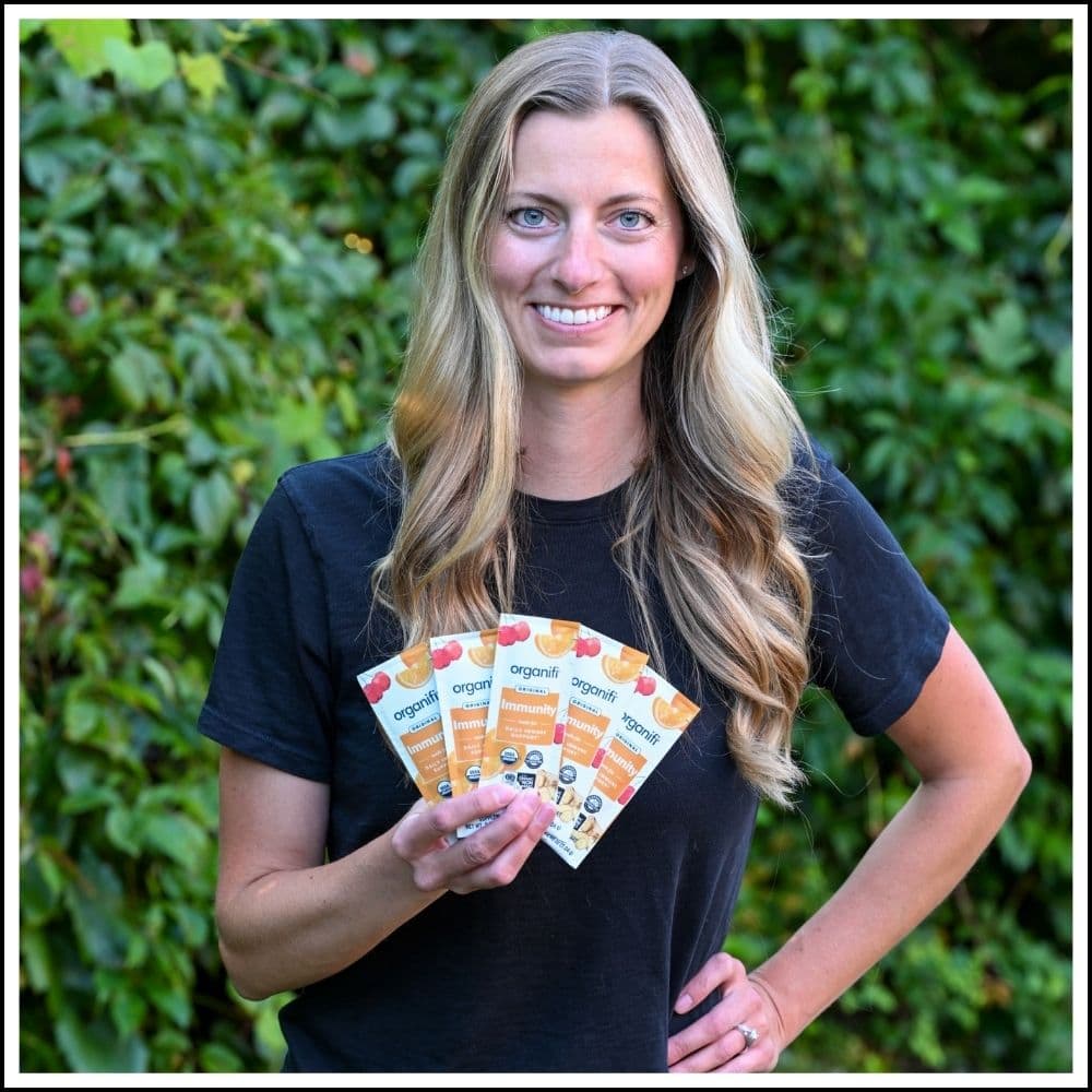 Photo of Jacki holding her favorite Organifi product, Immunity.