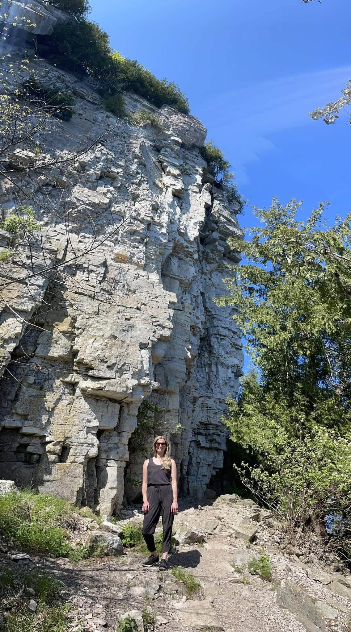 peninsula state park hike, photo of jacki in front of rock formation on door county itinerary