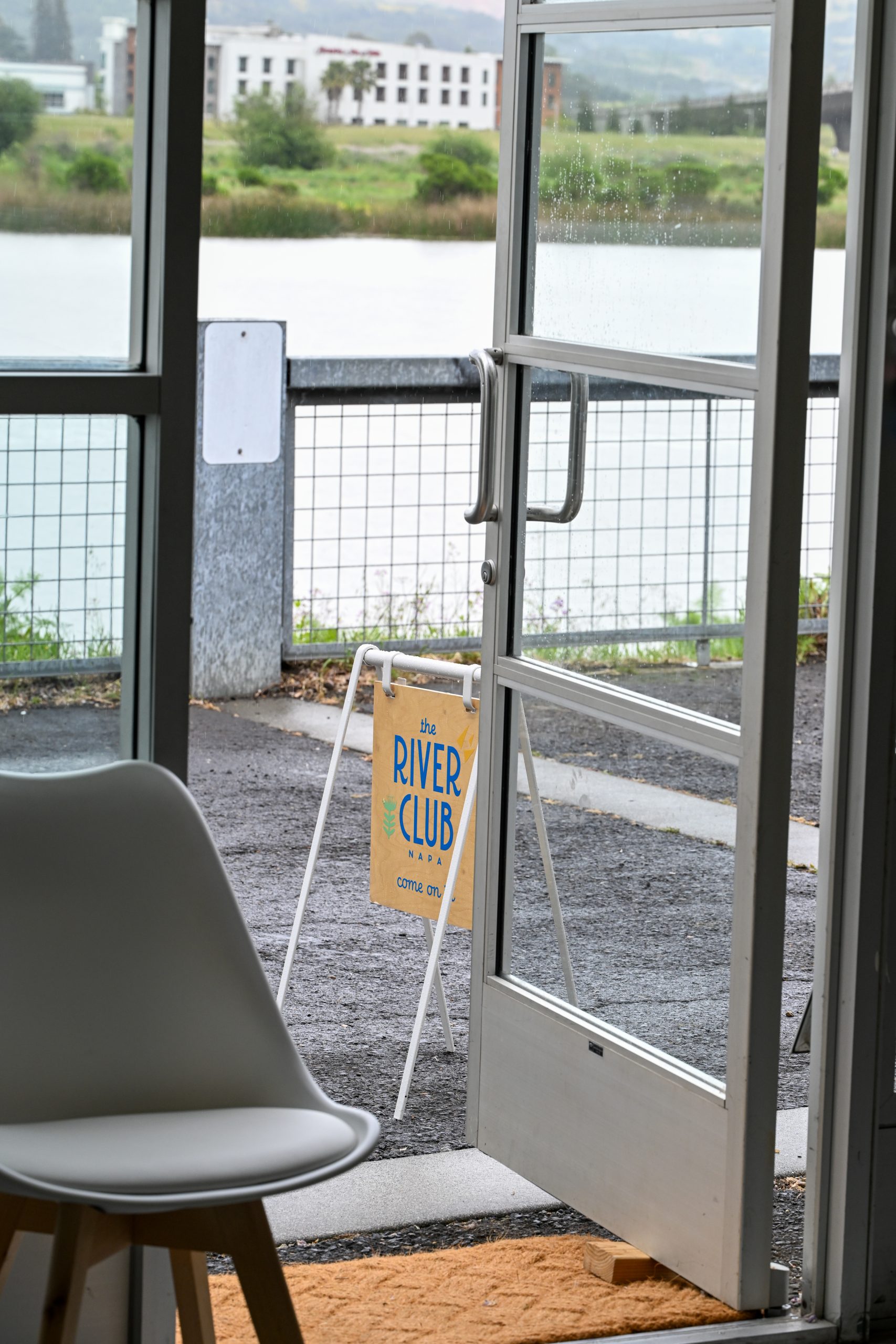 the river club sign viewing the river outside in napa valley