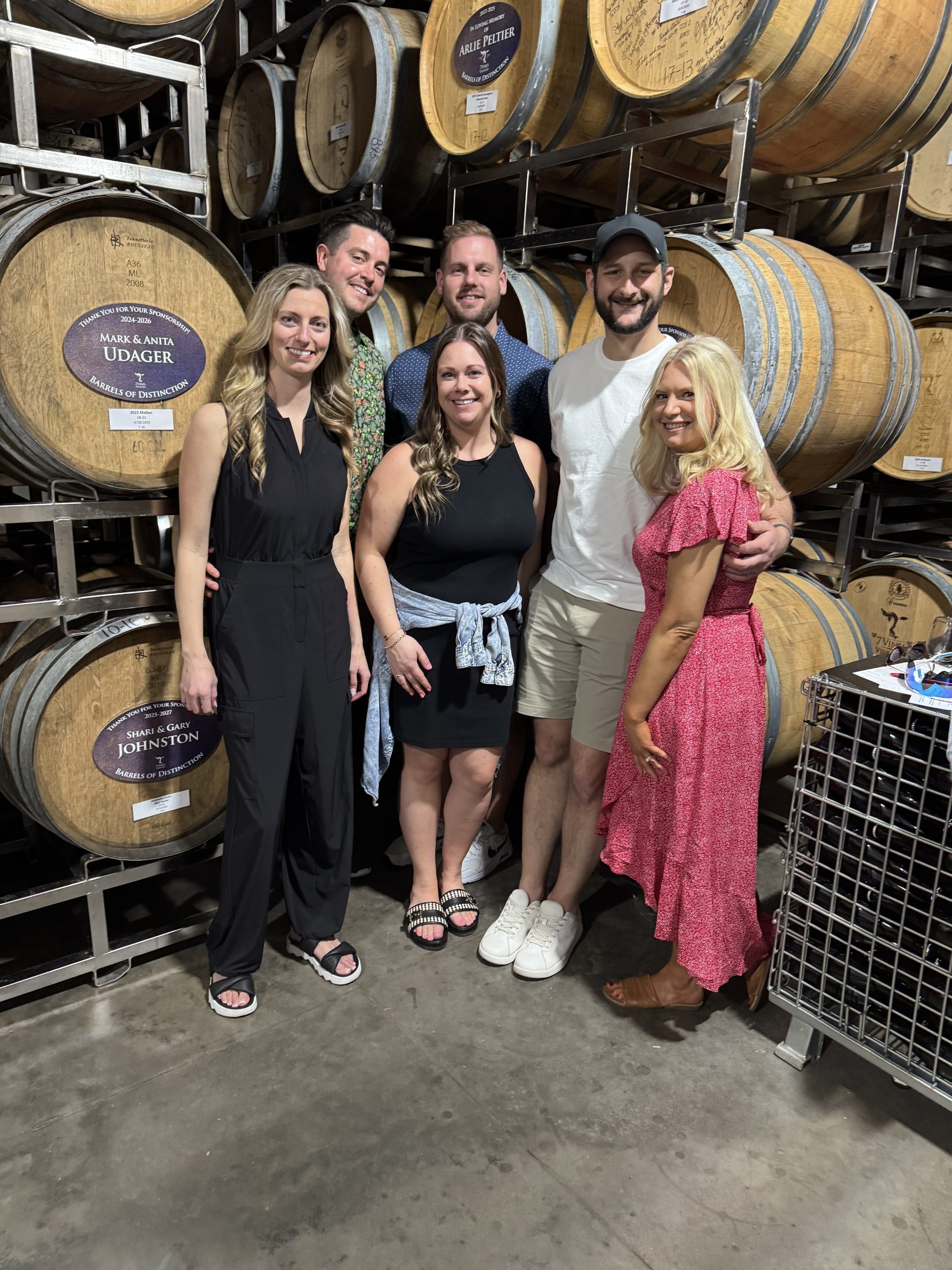 group of friends in the barrel room at 7 vines vineyard in dellwood, mn 