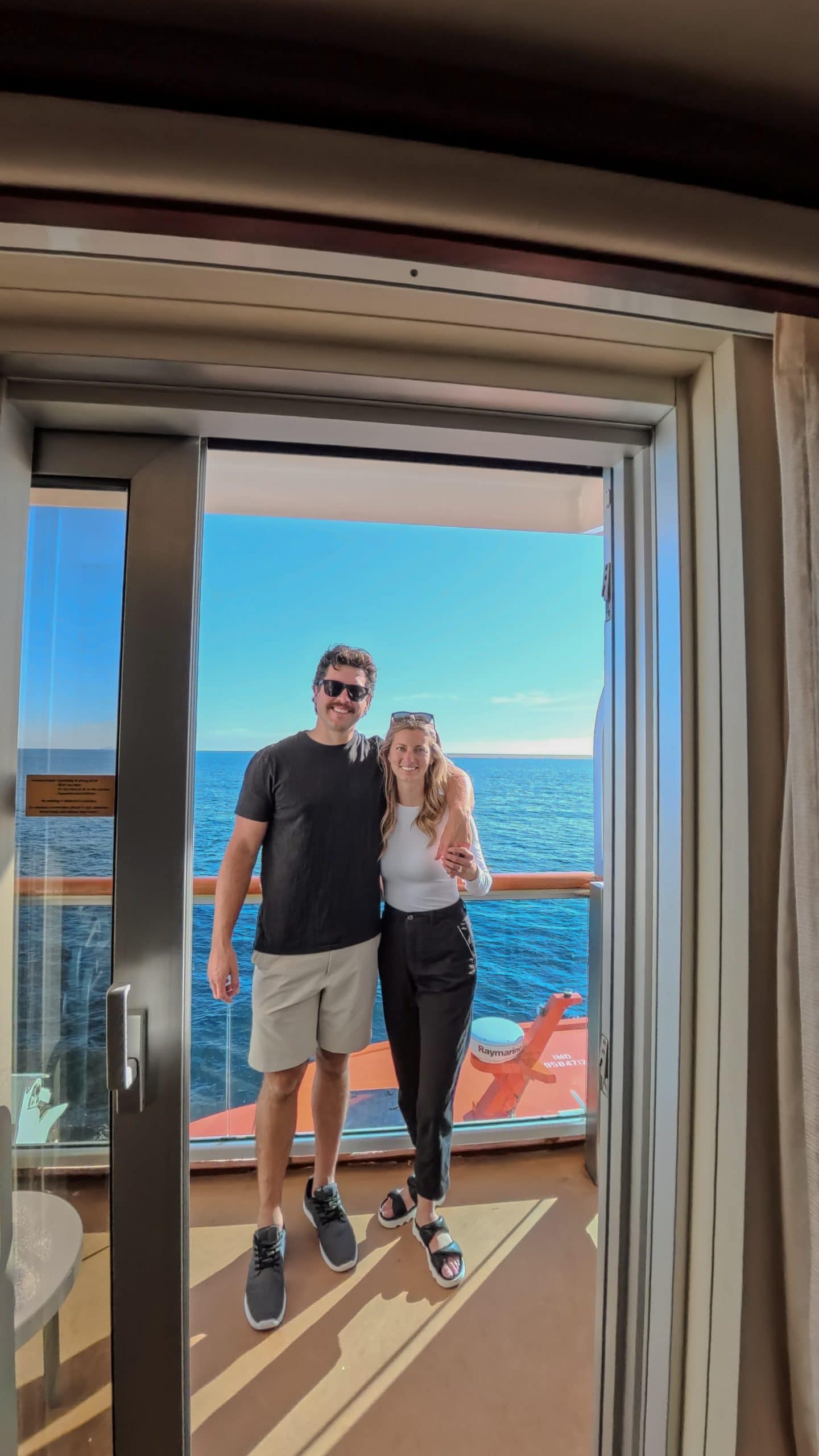 smart casual night on the royal princess in Alaska, James and Jacki posing on balcony. image on my Alaska Cruise Packing List post.